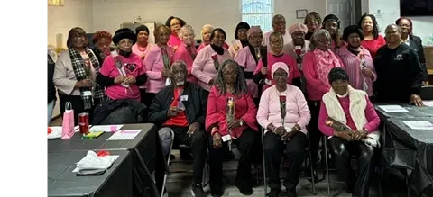 Community members gathered together at an indoor Hand of the King event