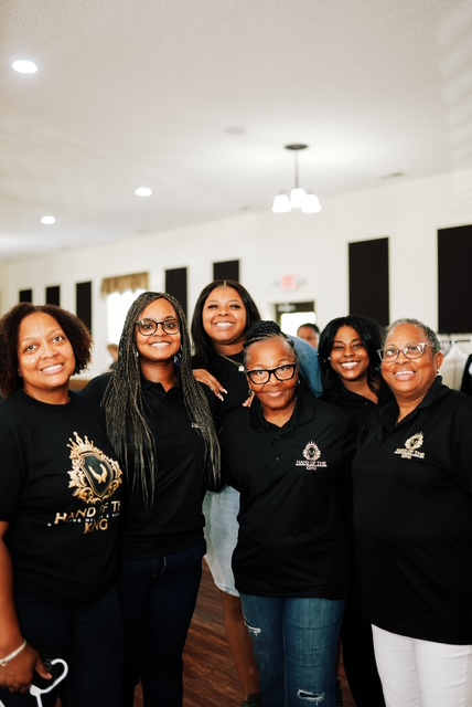 Hand of the King team members in matching black shirts at the Clothing Giveaway