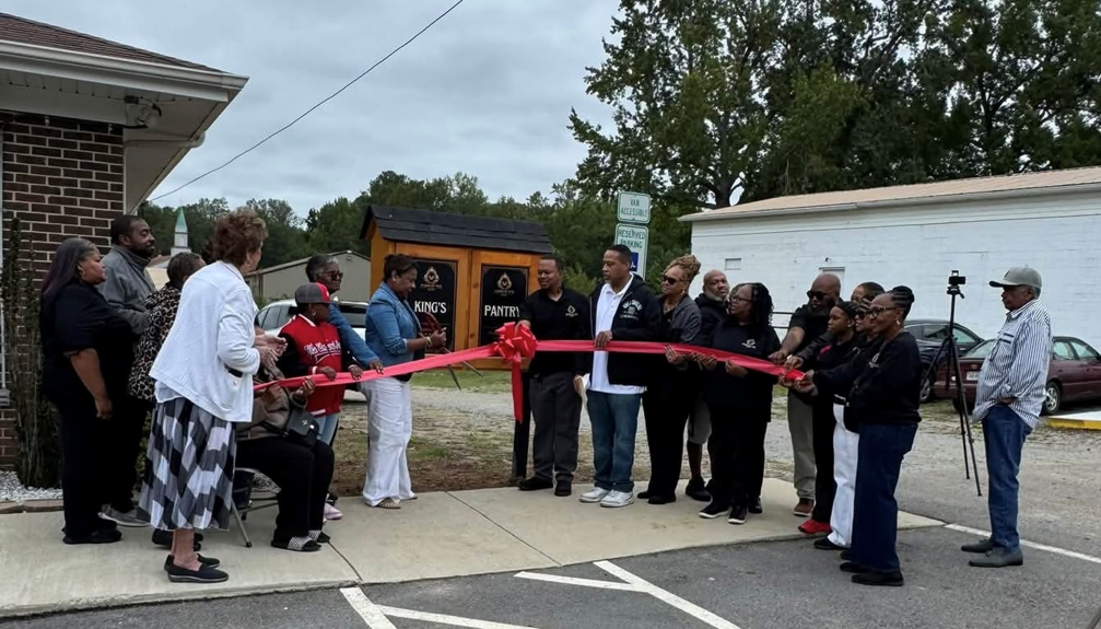 Large group of Hand of the King members and community supporters at the King's Pantry ribbon cutting