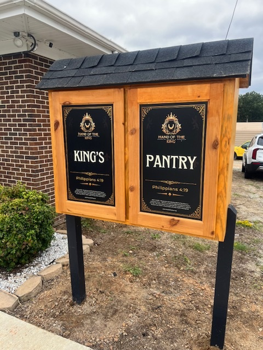King's Pantry wooden structure with Hand of the King signage and Philippians 4:19 scripture