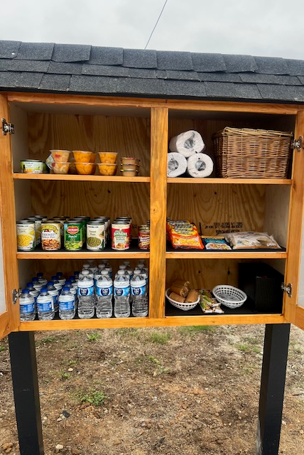 King's Pantry fully stocked with canned goods, water, snacks, and household supplies